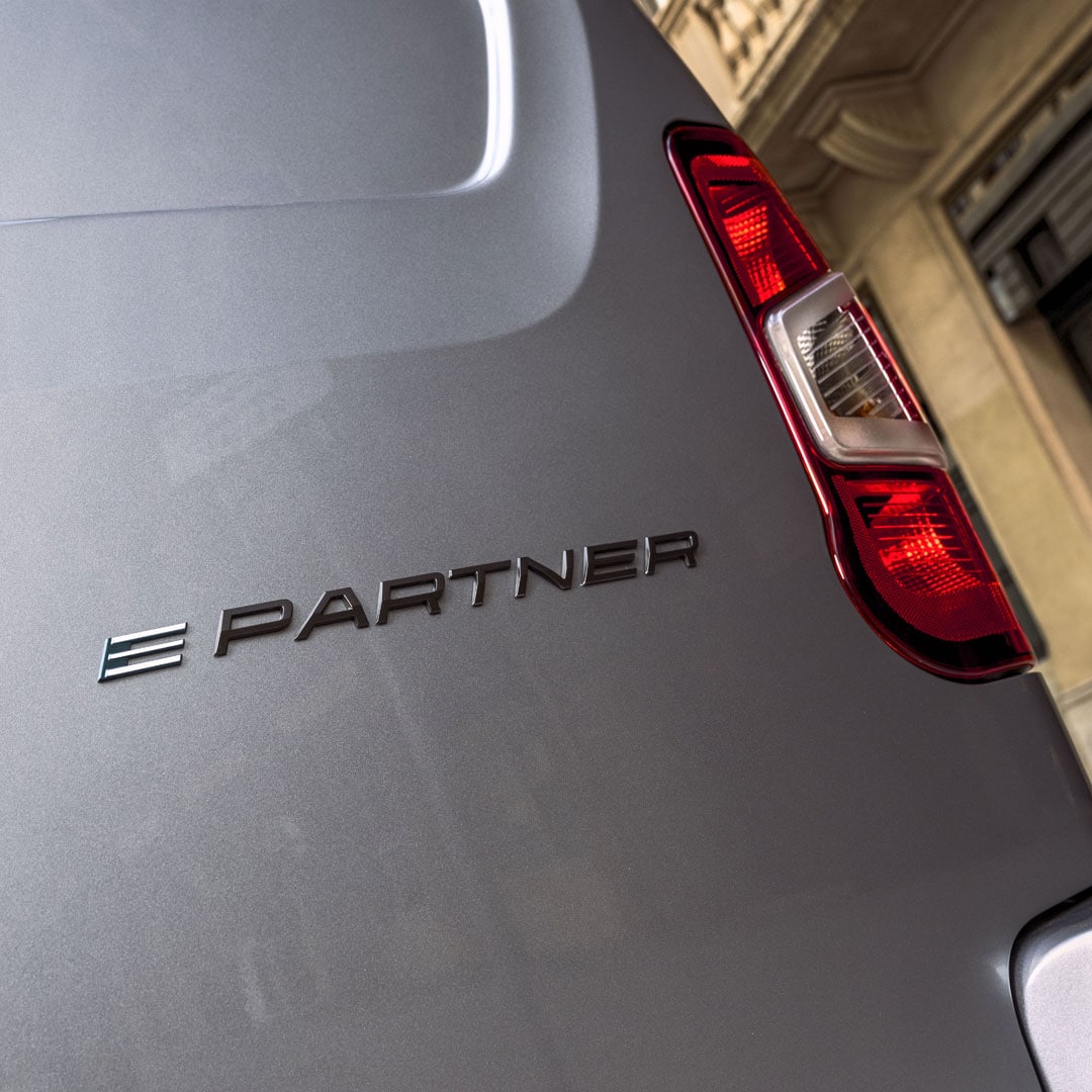 Woman inside a customized PEUGEOT E-Partner with refrigerated interior panels